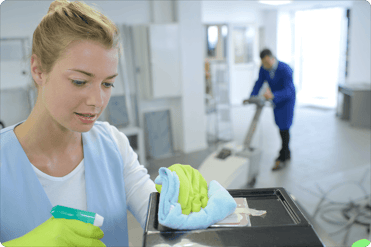 woman cleaning a surface with yellow gloves